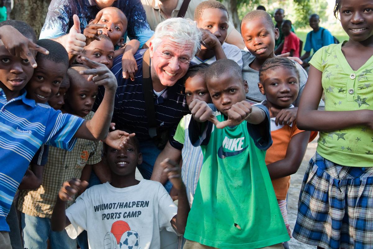 Foster Friess with Haitian children in 2010. (Courtesy of Foster's Outriders)