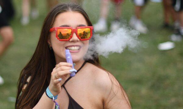 A festival-goer is seen vaping at Reading Festival in Reading, west of London, on Aug. 27, 2021. (Daniel Leal/AFP via Getty Images)