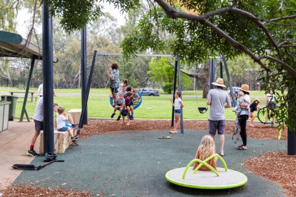 Regional Australia Institute (RAI), an independent think-tank, said that increasing overseas migration is crucial to the economic growth and sustainability of the outer fringes of cities and towns in Regional Australia. Adults look on as children play in a park in the regional Australian city of Dubbo, Australia, on Nov. 7, 2021. (Jenny Evans/Getty Images)