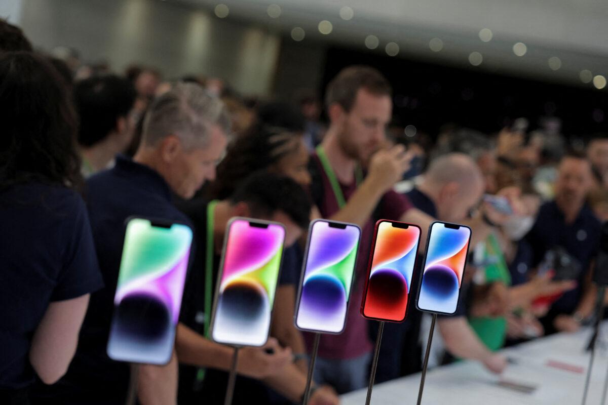 Guests look at the new iPhone 14 at an Apple event at their headquarters in Cupertino, Calif., on Sept. 7, 2022. (Carlos Barria/Reuters)