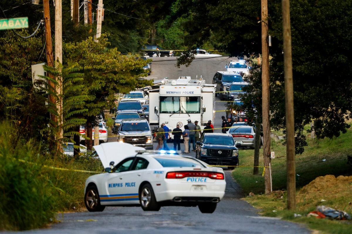 Memphis police officers search an area where a body had been found in South Memphis, Tenn., on Sept. 5, 2022. (Mark Weber/Daily Memphian via AP)