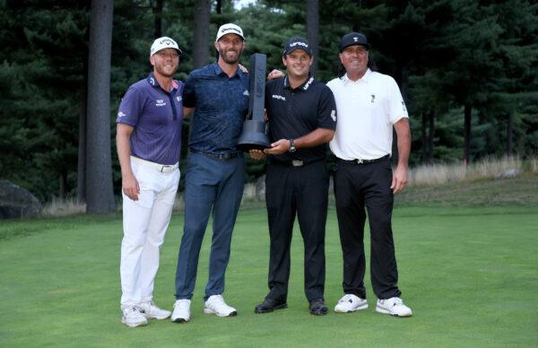 Talor Gooch, Dustin Johnson, Patrick Reed and Pat Perez pose with the Team winner's trophy during Day Three of the LIV Golf Invitational - Boston at The Oaks golf course at The International in Bolton, Mass., on Sept. 4, 2022. (Andy Lyons/Getty Images)