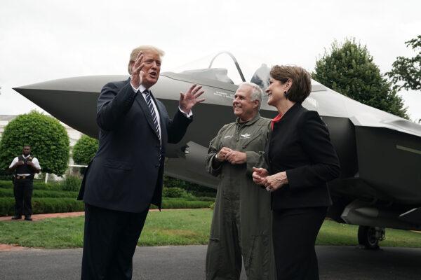 Then-U.S. President Donald Trump (L) talks to Chairman, President, and CEO of Lockheed Martin Marillyn Hewson (R) and Director and Chief Test Pilot Alan Norman (2nd L) in front of an F-35 fighter jet during the 2018 Made in America Product Showcase at the White House on July 23, 2018. (Alex Wong/Getty Images)