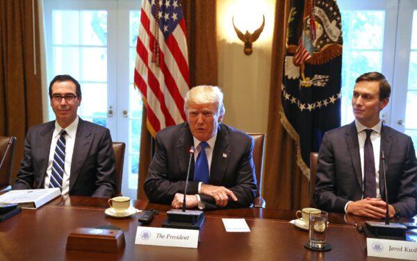 Then-U.S. President Donald Trump, flanked by his son-in-law Jared Kushner (R) and then-Treasury Secretary Steven Mnuchin, heads a meeting at the White House in Washington, on July 25, 2017. (Tasos Katopodis/AFP via Getty Images)