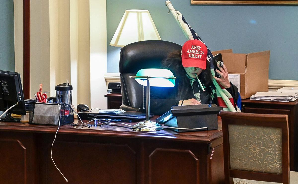 Megan Paradise sits at a desk in the office of House Speaker Nancy Pelosi (D-California) on Jan. 6, 2021. (Attorney Brad Geyer/Screenshot via The Epoch Times)