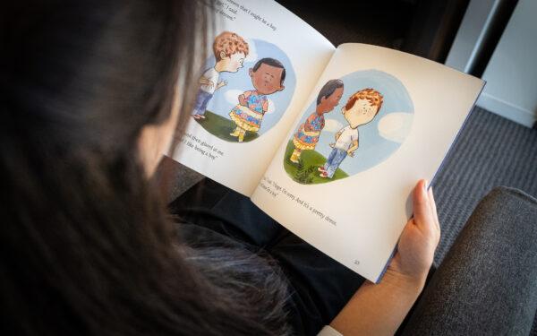 A person reads a transgender children's book in Irvine, Calif., on Aug. 30, 2022. (John Fredricks/The Epoch Times)