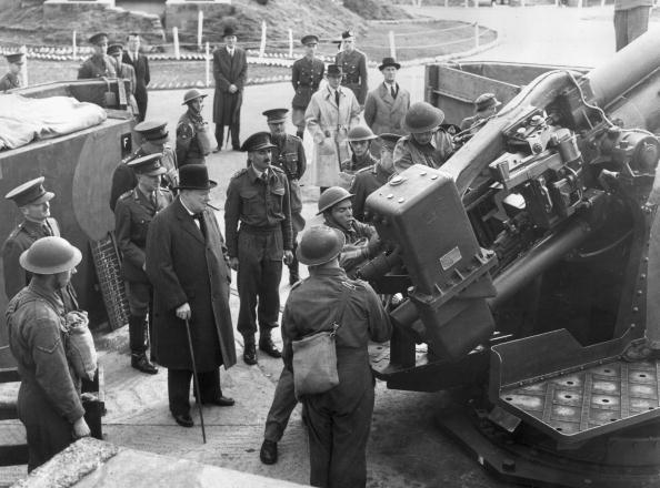 In 1941, British Prime Minister Winston Churchill observes British soldiers in London,  operating an anti-aircraft gun. (Hulton Archive/Getty Images)