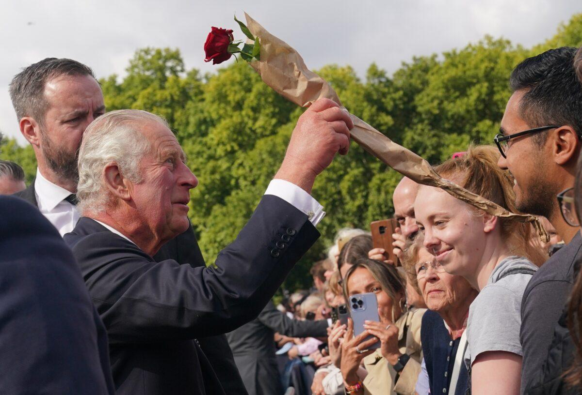 King Charles III is greeted by well-wishers during a walkabout to view tributes left outside Buckingham Palace following the death of Queen Elizabeth II, in London on Sept. 9, 2022. (Yui Mok/PA Media)