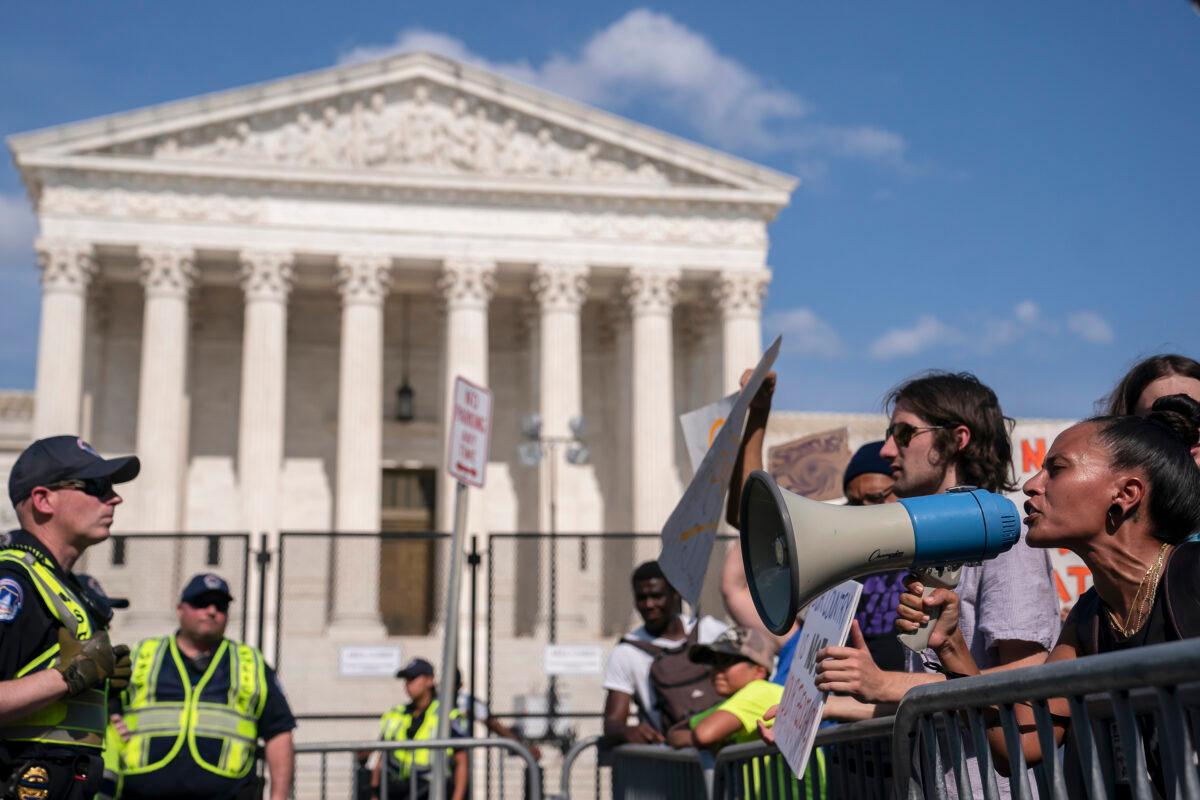Abortion-rights activists (R) argue with anti-abortion activists in front of the Supreme Court in Washington on June 26, 2022. (Nathan Howard/Getty Images)