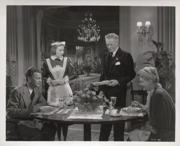 (L–R) Joseph Cotten, Loretta Young, Charles Bickford, and Ethel Barrymore at the dining table in a scene from "The Farmer's Daughter." (MoviestillsDB)