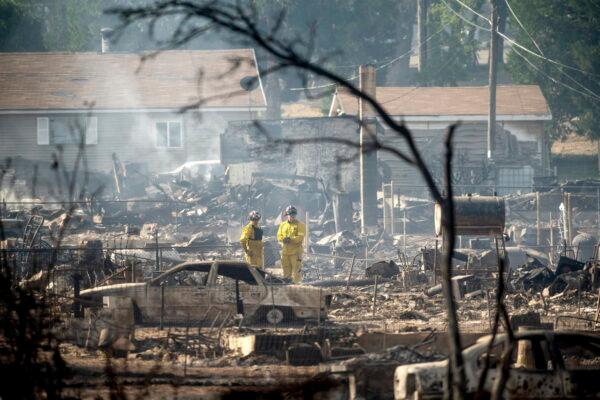 Firefighters survey homes on Wakefield Avenue destroyed by the Mill fire in Weed, Calif., on Sept. 3, 2022. (Noah Berger/AP Photo)