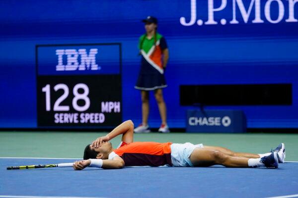 Carlos Alcaraz, of Spain, lies on the court after beating Jannik Sinner, of Italy, during the quarterfinals of the U.S. Open tennis championships in New York, on Sept. 8, 2022. (Frank Franklin II/AP Photo)