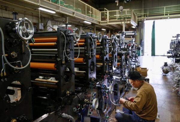 A worker checks machinery at a factory in Higashiosaka, Japan, on June 23, 2022. (Sakura Murakami/Reuters)