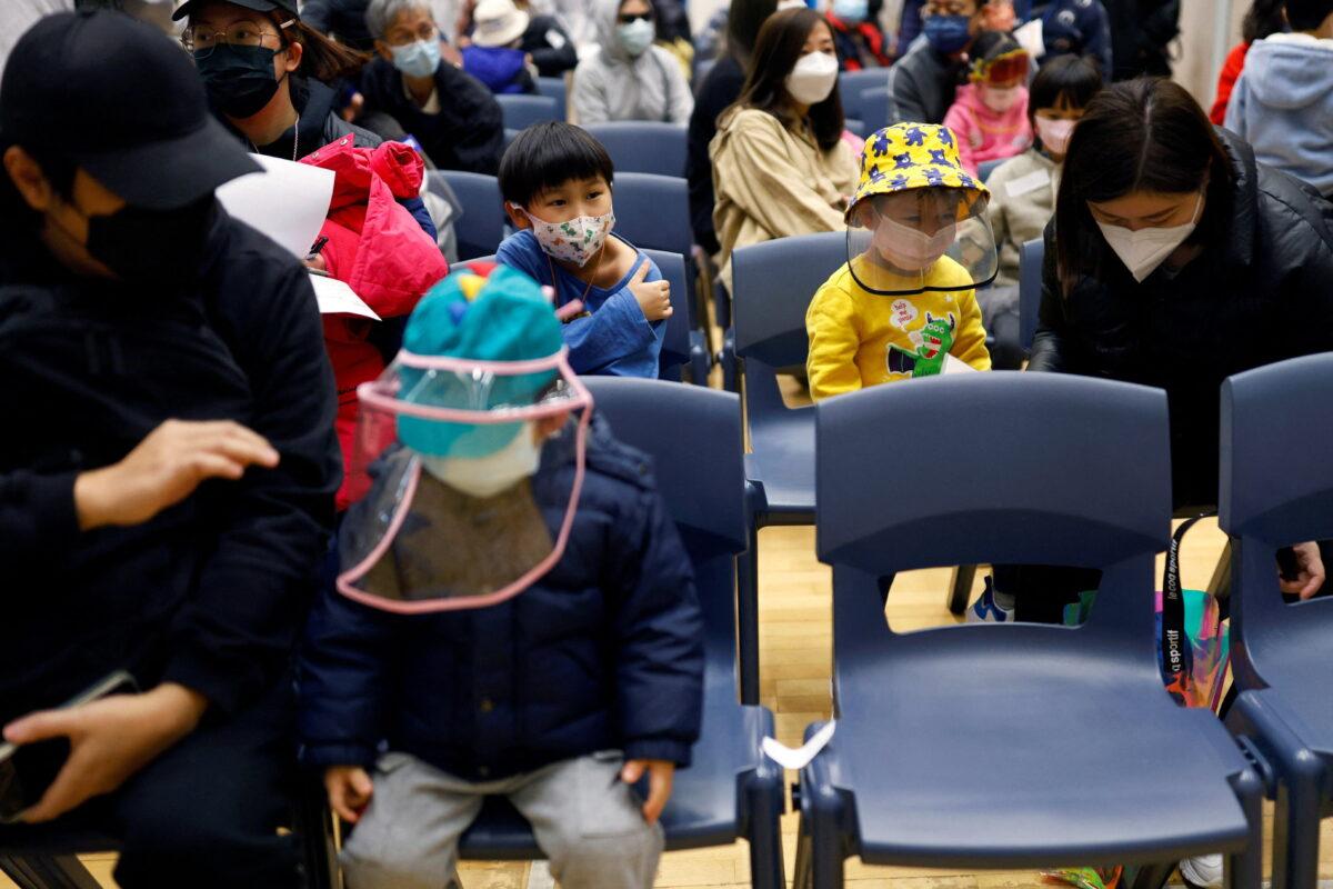 Children rest at a community vaccination center after receiving a dose of Sinovac Biotech's CoronaVac COVID-19 vaccine following the COVID outbreak, in Hong Kong on Feb. 25, 2022. (Tyrone Siu/Reuters)
