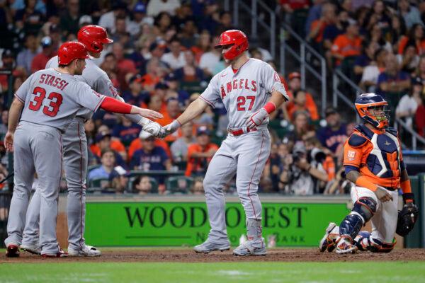 From left to right, Los Angeles Angels' Max Stassi, Shohei Ohtani and Mike Trout celebrate a two-home run by Trout behind Houston Astros catcher Martin Maldonado that also scored Stassi during the sixth inning of a baseball game Friday, Sept. 9, 2022, in Houston. (AP Photo/Michael Wyke)
