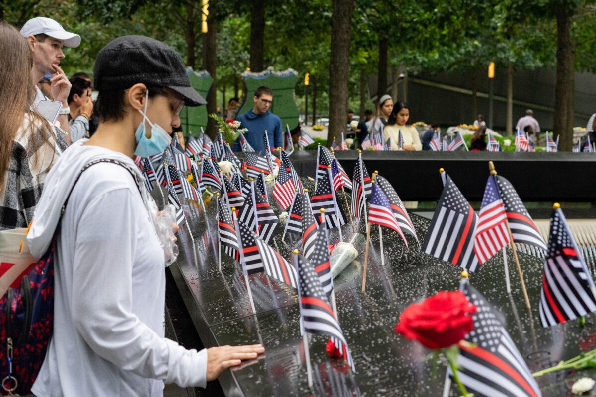 People pay respects at the National September 11 Memorial Museum in New York on Sept. 11, 2022. (Chung I Ho/The Epoch Times)