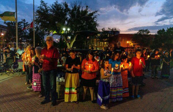 People gather at a vigil to remember the victims of a mass stabbing incident at James Smith Cree Nation and Weldon, Sask., in front of City Hall in Prince Albert, Sask., on Sept. 7, 2022. (The Canadian Press/Heywood Yu)