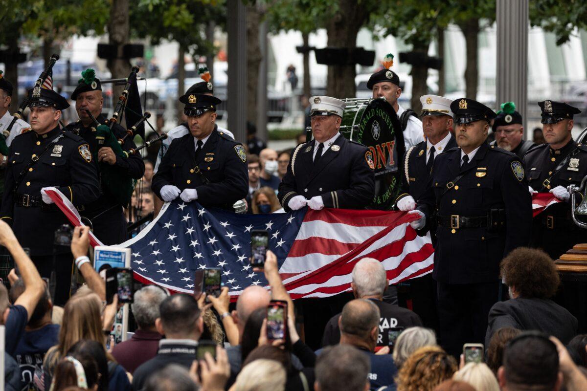 Members of New York Fire Department raise a U.S. flag at the 9/11 Memorial in New York on Sept. 11, 2022, on the 21st anniversary of the attacks on the World Trade Center, Pentagon, and Shanksville, Pennsylvania. (Yuki Iwamura/AFP via Getty Images)
