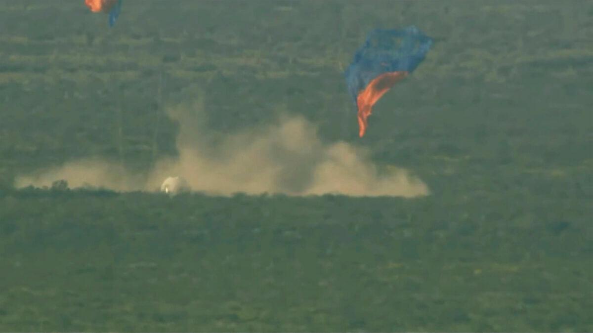 A capsule, containing science experiments after a launch failure, parachutes onto the desert floor on Sept. 12, 2022. (Blue Origin via AP)