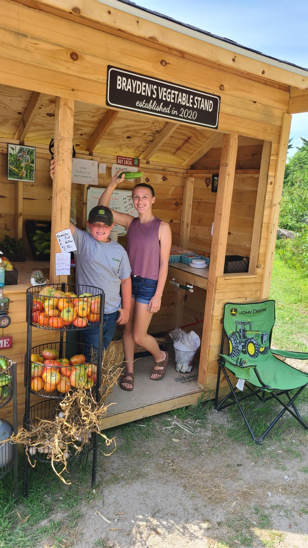 Brayden and his sister Emma at his produce stand, Brayden’s Vegetable Stand. (Courtesy of <a href="https://www.facebook.com/braydensvegetablestand">Kari Nadeau</a>)