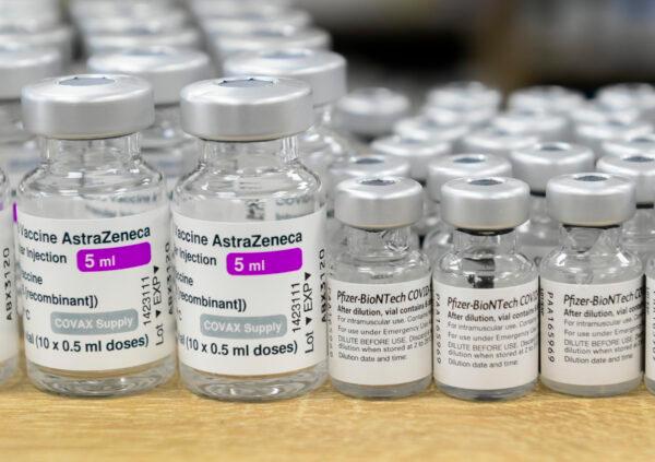 Vials of Pfizer-BioNTech and Oxford-AstraZeneca COVID-19 vaccines sit on the counter at the Junction Chemist Pharmacy in Toronto, Canada, on June 18, 2021. (Nathan Denette/The Canadian Press)