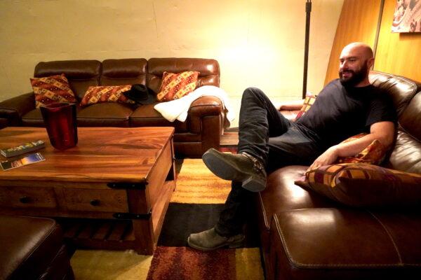 Dante Vicino kicks back in his furnished den inside his converted bunker at Vivos xPoint on Sept. 7. (Allan Stein/The Epoch Times)