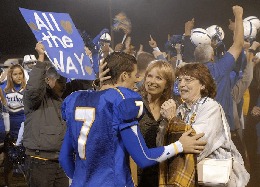 Panthers' QB1 (first string quarterback), Matt Saracen (Zach Gilford, foreground), his mom Shelby (Kim Dickens), and grandmother (Louanne Stephens) celebrate a win, in "Friday Night Lights." (Universal Television)