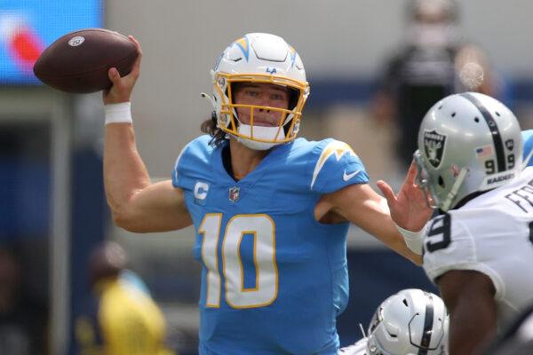Quarterback Justin Herbert (10) of the Los Angeles Chargers attempts a pas during the first half against the Las Vegas Raiders at SoFi Stadium in Inglewood, Calif., on Sept. 11, 2022. (Harry How/Getty Images)