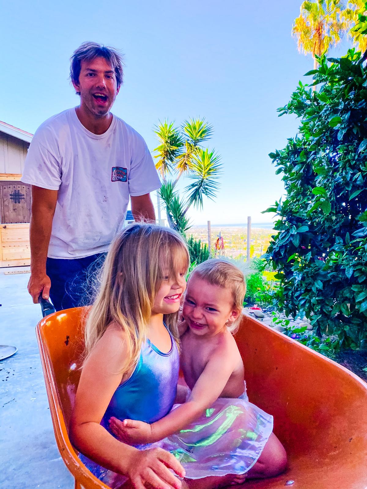 Stelios Koutroumbis working outside with his kids, Evelyn and Christopher. (Courtesy of <a href="https://www.instagram.com/mykidsaredirtyagain/">Taylor Raine</a>)