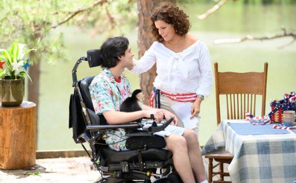 Charlie Rowe as wheelchair-bound Nate Gibson holds his service monkey Gigi as he speaks with Marcia Gay Harden as his mother Claire Gibson in "Gigi & Nate."(Roadside Attractions)