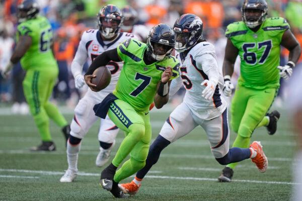 Seattle Seahawks quarterback Geno Smith (7) scrambles against the Denver Broncos during the first half of an NFL football game in Seattle, Sept. 12, 2022. (Stephen Brashear/AP Photo)