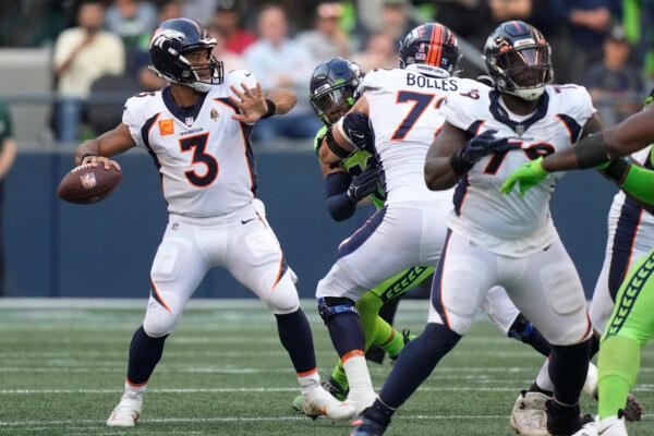 Denver Broncos quarterback Russell Wilson (3) passes for a touchdown against the Seattle Seahawks during the first half of an NFL football game in Seattle, Sept. 12, 2022. (Stephen Brashear/AP Photo)