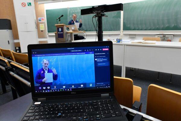 Professor Jan Govaerts at The School of Physics at UCLouvain gestures as he teaches alone in a small lecture theatre of the university at Louvain-la-Neuve, on the outskirts of Brussels on Nov. 3, 2020. (John Thys/AFP via Getty Images)