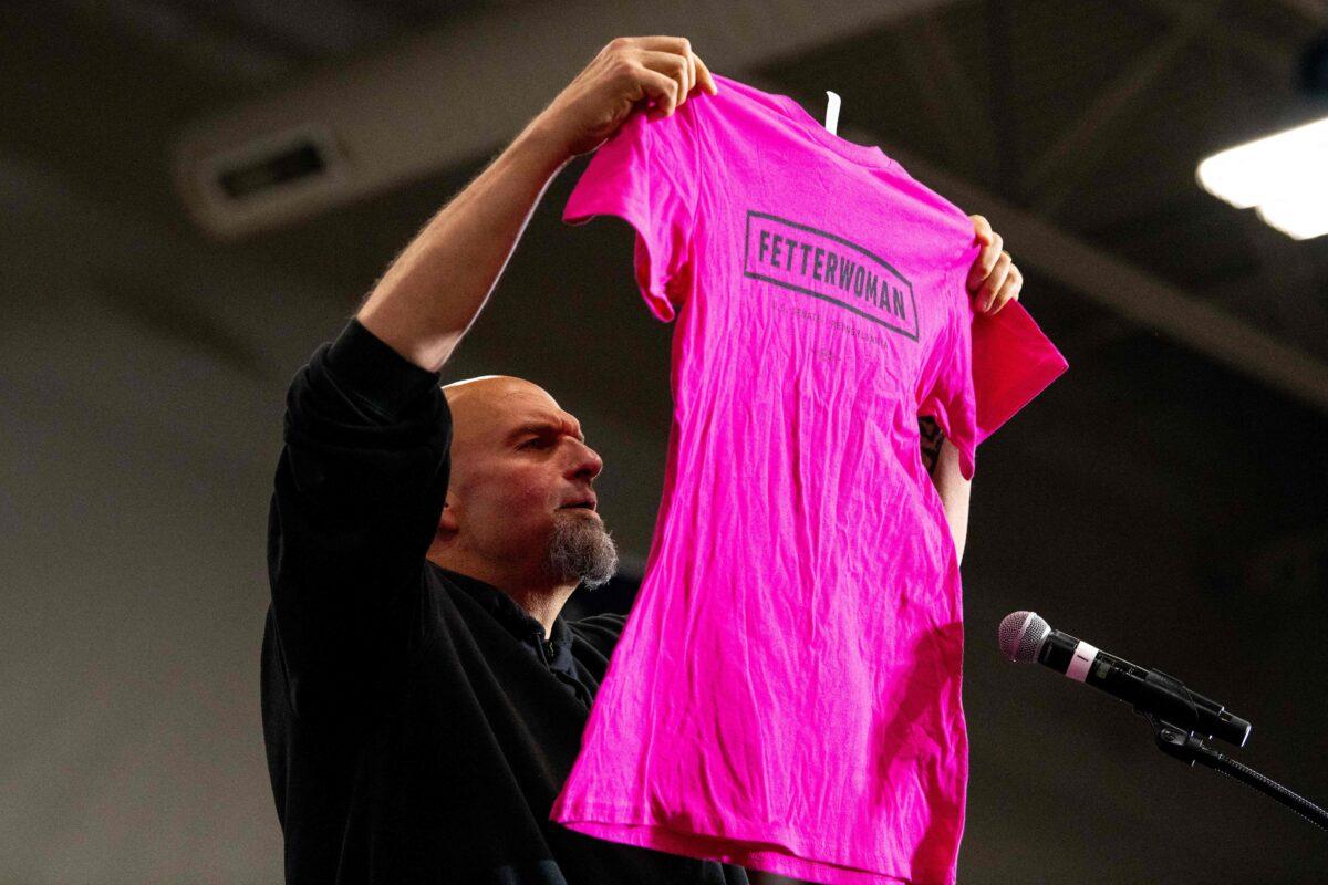 Pennsylvania Lt. Governor and U.S. senatorial candidate John Fetterman holds up a "Fetterwoman" campaign shirt while delivering remarks during a "Women for Fetterman" rally at Montgomery County Community College in Blue Bell, Pa., on Sept. 11, 2022. (Kriston Jae Bethel/AFP via Getty Images)