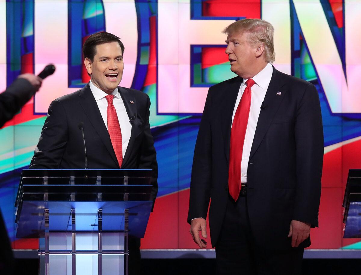 Sen. Marco Rubio (R-Fla.) and Donald Trump, then-Republican presidential candidates, chat during a commercial break in the broadcast of the Republican Presidential Primary Debate on the campus of the University of Miami in Coral Gables, Fla., on March 10, 2016. (Joe Raedle/Getty Images)