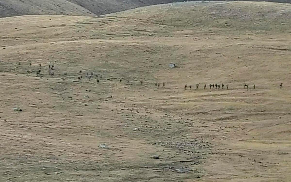 Azerbaijanian servicemen cross the Armenian–Azerbaijani border and approach the Armenian positions in a still from video released on Sept. 13, 2022. (Armenian Defense Ministry via AP)