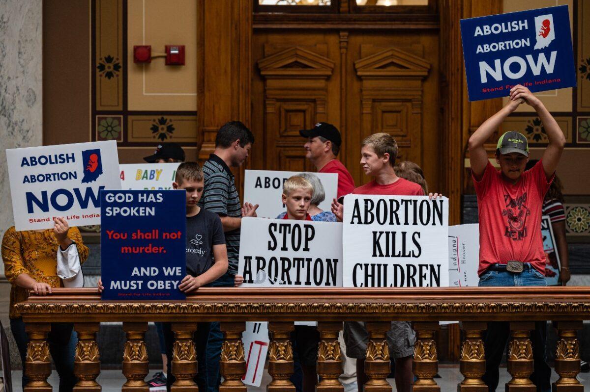 Pro-life protesters hold up signs inside the Indiana State Capitol building in Indianapolis, Ind., on July 25, 2022. Indiana became the first state to pass an abortion ban after the Supreme Court overturned Roe v. Wade this summer. (Jon Cherry/Getty Images)