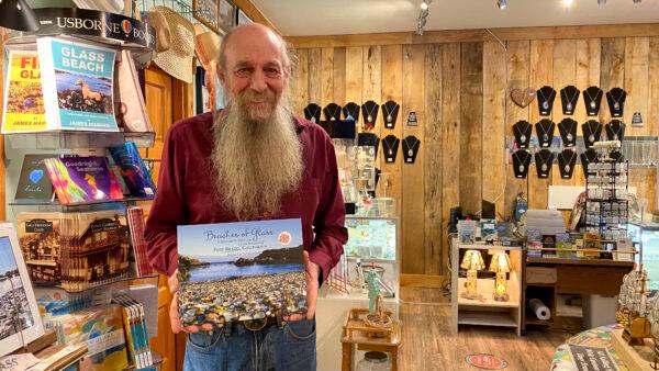 Joseph Cass Forrington holds his book about sea glass at the Sea Glass Museum in Fort Bragg, Calif., on Sept. 5, 2022. (Ilene Eng/NTD)