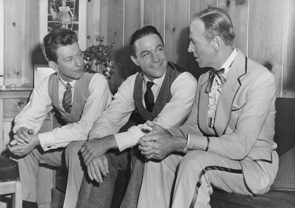 (L-R) Actors and dancers Donald O'Connor (1925-2003), Gene Kelly (1912-1996) and Fred Astaire (1899-1987) pictured seated together for a conference in Kelly's dressing room on the set of "Singin' in the Rain," circa 1952. (Pictorial Parade/Archive Photos/Getty Images)