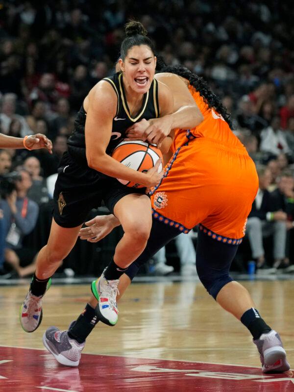 Las Vegas Aces guard Kelsey Plum (10) drives around Connecticut Sun center Brionna Jones (42) during the first half in Game 2 of a WNBA basketball final playoff series in Las Vegas, Sept. 13, 2022. (John Locher/AP Photo)