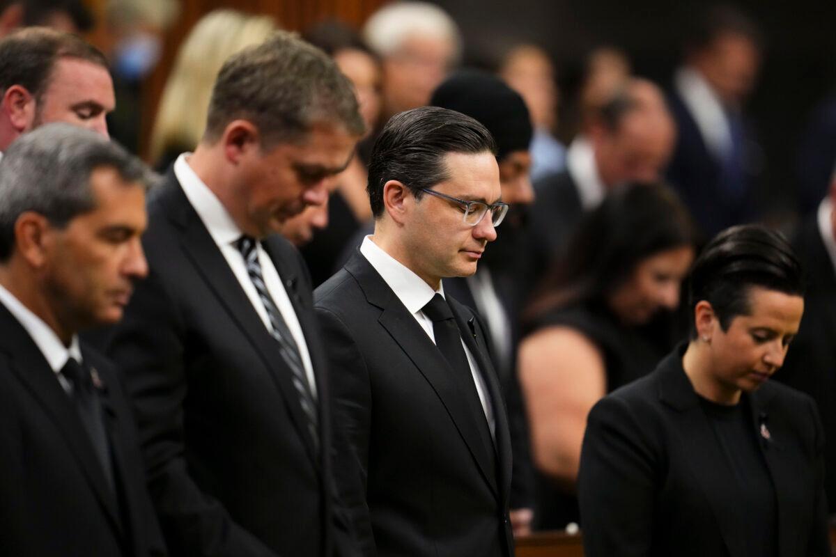 Conservative leader Pierre Poilievre and fellow members of Parliament take a moment of silence in the House of Commons on Parliament Hill in Ottawa on Sept. 15, 2022. (The Canadian Press/Sean Kilpatrick)