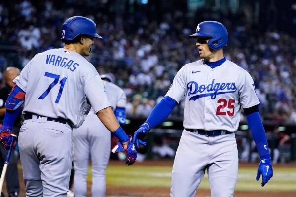 Los Angeles Dodgers' Trayce Thompson (25) celebrates his home run against the Arizona Diamondbacks with Miguel Vargas (71) during the fourth inning of a baseball gamein Phoenix, on Sept. 14, 2022. (Ross D. Franklin/AP Photo)