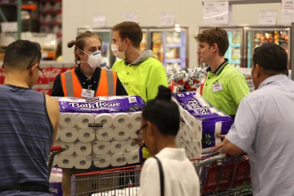 Staff members assist shoppers at Costco Perth in Perth, Australia, on March 19, 2020. (Paul Kane/Getty Images)