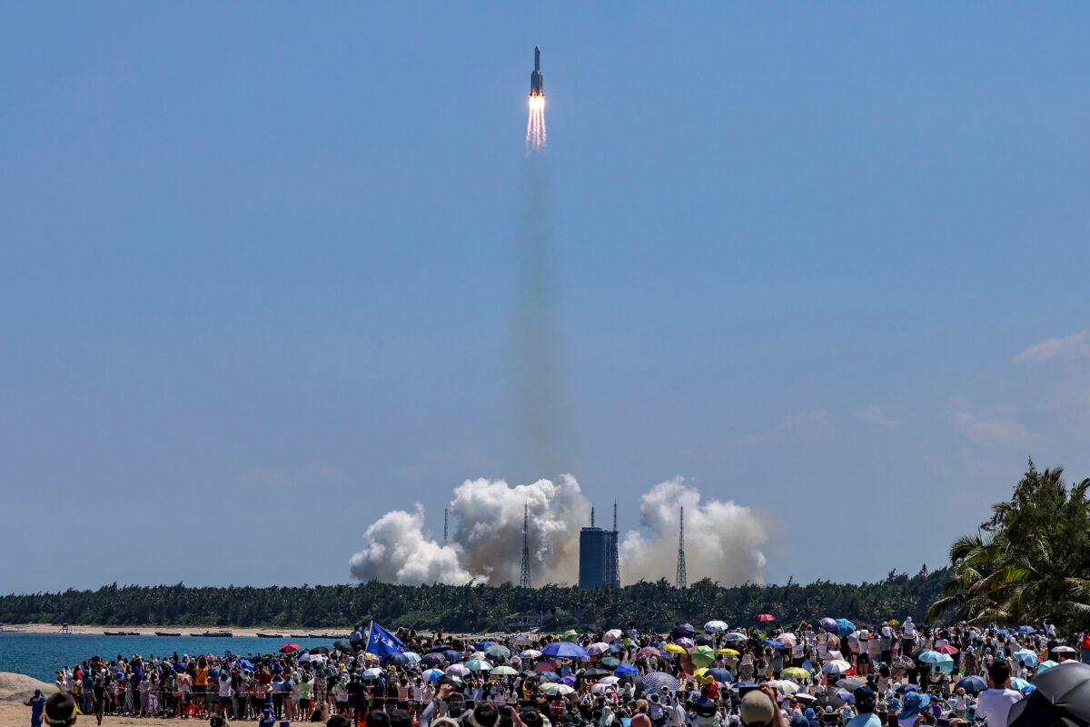 People gather at the beach as they watch the Long March 5B Y3 carrier rocket, carrying the Wentian lab module, lift off from the Wenchang Space Launch Center in Wenchang, in southern China's Hainan Province, on July 24, 2022. (Zhang Liyun/Xinhua via AP)