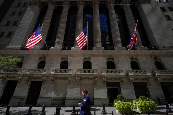 A trader looks over his cell phone outside the New York Stock Exchange, on Sept. 14, 2022. (Mary Altaffer/AP Photo)