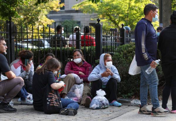  Illegal immigrants from Central and South America wait near the residence of Vice President Kamala Harris after being dropped off in Washington on Sept. 15, 2022. (Kevin Dietsch/Getty Images)