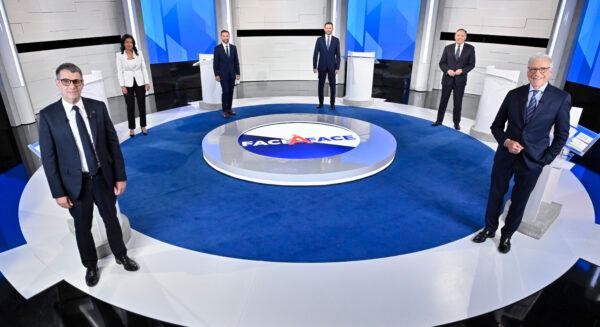 (L-R) Conservative Leader Eric Duhaime, Liberal Leader Dominique Anglade, Quebec Solidaire co-spokesperson Gabriel Nadeau-Dubois, Parti-Quebecois Leader Paul St-Pierre Plamondon, CAQ Leader Francois Legault and moderator Pierre Brunei, stand on the set prior to the leaders debate in Montreal, on Sept. 15, 2022. (Martin Chevalier/The Canadian Press)