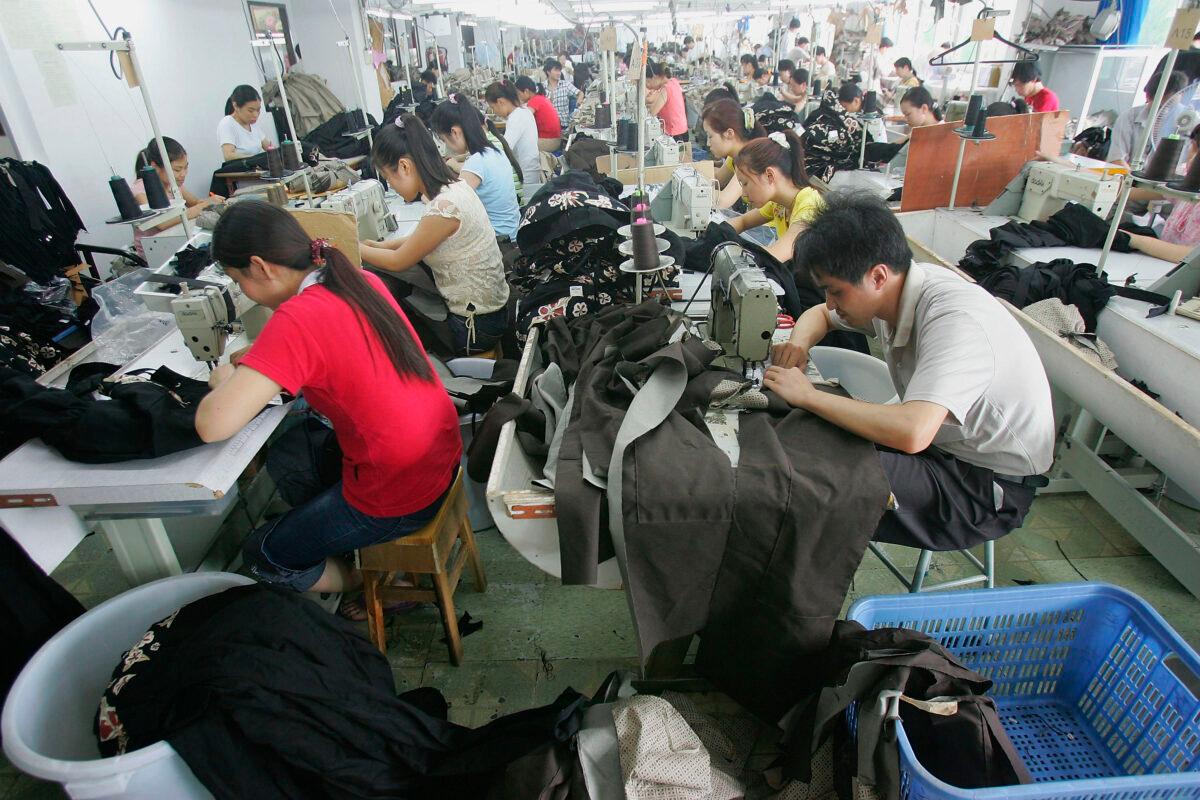 Chinese laborers work at a garment factory in Shenzhen, of Guangdong Province, China, on May 4, 2005. (China Photos/Getty Images)