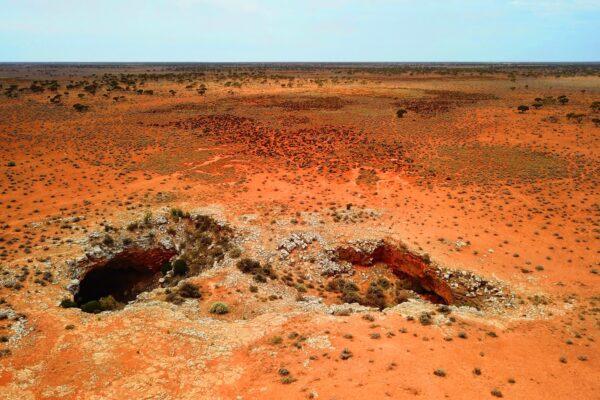 Twin karst collapses into the Mullamullang Cave system on the Nullarbor Plain. (Courtesy of Matej Lipar)