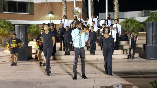 Antoine Miller, bandleader and founder of Sounds of Success Community Marching Band, with some of his musicians and dancers as they perform on television for Mayor Thomas Masters at City Hall in Riviera Beach, Florida, in 2019. (Courtesy of Sounds of Success)